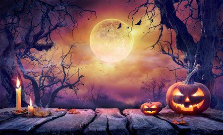 Halloween Table - Old Wooden Plank With Orange Pumpkin In Purple Landscape With Moonlightの写真素材
