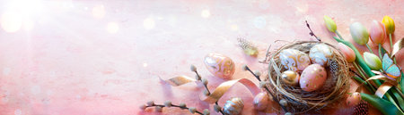 Easter - Eggs In Nest On Pink Table With Golden Decoration And Tulipsの写真素材