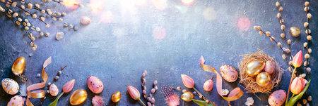 Easter - Eggs In Nest And Tulips With Golden And Pink Decorations On Blue Table With Sunshineの写真素材