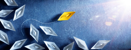 Yellow Paper Boat Change Direction - Leadership Vision And Opportunity - Sailing Against The Tideの写真素材