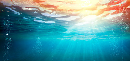 Underwater Ocean With Sunset - Abyss With Sunlight - Abstract Defocused Background And Glowing Effectの写真素材
