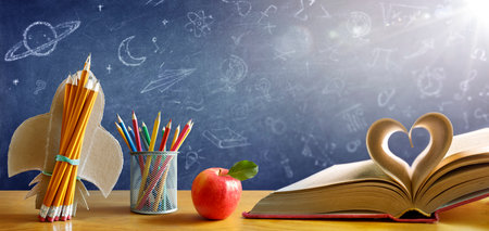Back To School - Book With Rocket And Colorful Pencils On Desk With Blackboard - Startup Conceptの写真素材