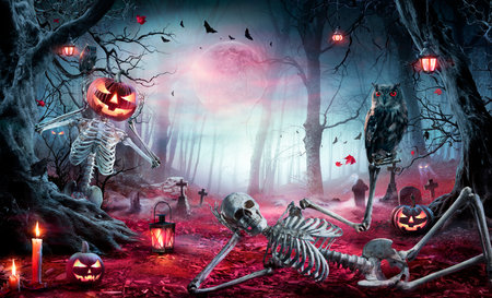 Halloween - Skeletons In Spooky Forest At Moonlight - Jack O' Lanterns In Cemetery At Twilightの写真素材