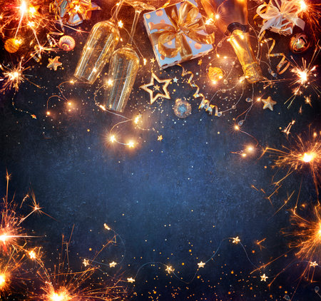 New Year Celebration - Lights With Champagne Glasses And Gift Boxes With Golden Ornaments On Blue Backgroundの写真素材