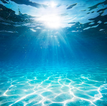 Underwater In Blue Sea - Deep Water Abyss With Abstract Sunshineの写真素材