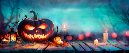 Halloween Pumpkins On Table At Twilight - Jack O' Lantern In Defocused Forestの写真素材
