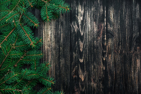 Spruce branches on a dark vintage wooden background. christmas conceptの写真素材