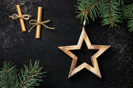 christmas background. star and spruce branches on a black backgroundの写真素材