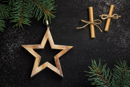 christmas background. star and spruce branches on a black backgroundの写真素材
