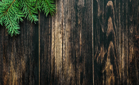 Spruce branches on a dark vintage wooden background. christmas conceptの写真素材