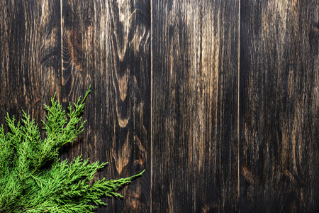 Fir branches on a dark vintage wooden background. christmas conceptの写真素材