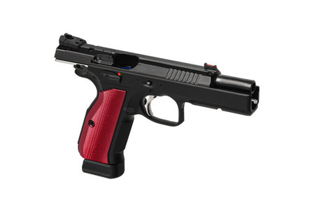 A modern black semi-automatic pistol with a red grip. A short-barreled weapon for self-defense and sport. Isolate on a white background.の写真素材