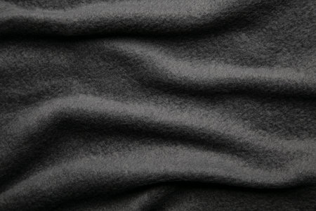 Texture of warm woolen fabric with folds. Gray wavy felt background.の写真素材