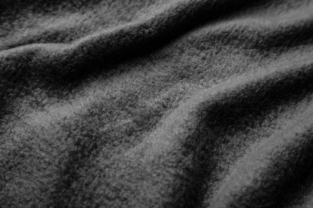 Texture of warm woolen fabric with folds. Gray wavy felt background.の写真素材