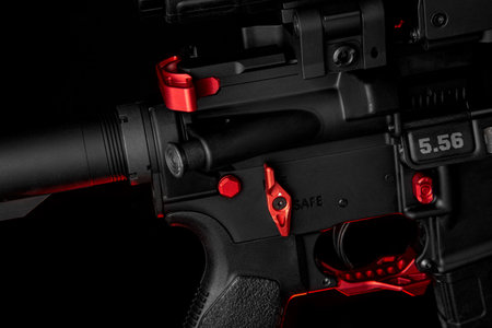 Close-up of the details of an automatic carbine. red elements. Black background.の写真素材