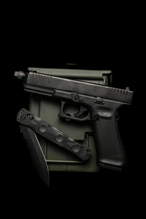 Modern semi-automatic pistol. A short-barrel weapon for self-defense. Folding penknife. Arming the police, special units and the army. Dark background.の写真素材