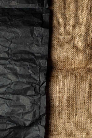 Burlap fabric texture and black crumpled paper. Rough vintage background.