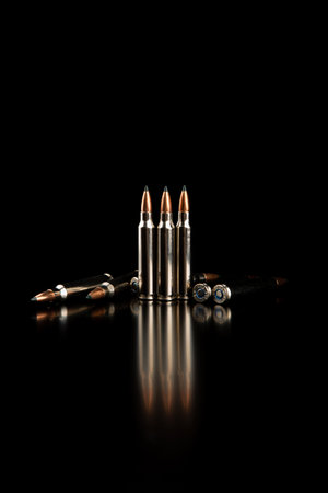 Bullet isolated on black background with reflexion. Rifle bullets close-up on black back. Cartridges for rifle and carbine on a black.の写真素材