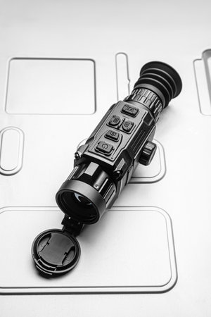 Modern monocular thermal imager isolate on a metal background. A device for fixing thermal radiation.の写真素材