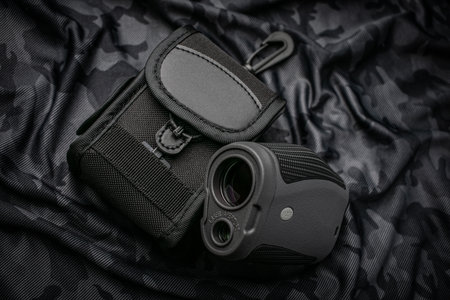 A small modern optical rangefinder. An electronic device for measuring distance. Dark camouflage...