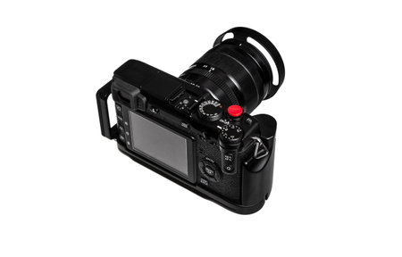A black digital camera with a large lens and a red shutter button, viewed from the back, showing the...