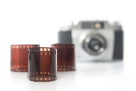 negative film and analog camera in background. selective focus. horizontal imageの写真素材