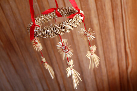 Straw Christmas ornament with red ribbonの写真素材