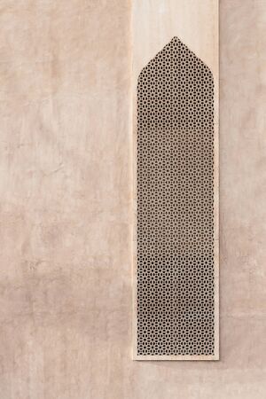 Wall of an oriental building with a window in a traditional pattern - Mashrabiya