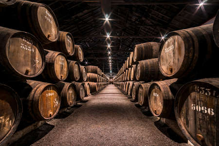 Vila Nova de Gaia, Porto, Portugal - Nov.22, 2019: Taylor's Port Wine Cellar. Barrels filled with wine, tightly stacked in rows in a special building for storing this product. Taylorâs is one of the oldest of the founding Port housesのeditorial素材