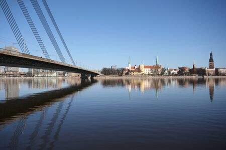 Old Town Panorama with River and Bridge Fragment in Sunny Dayの写真素材