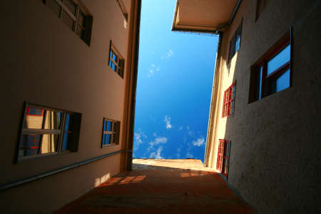 House wall with windows, reflections, shadowsの写真素材
