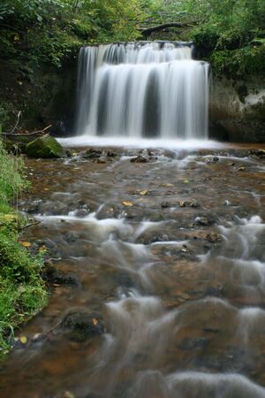 Waterfall in the forest on cloudy dayの写真素材