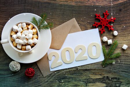 Figures 2020 background new year. Christmas composition, a Cup of hot cocoa with marshmallow and a...