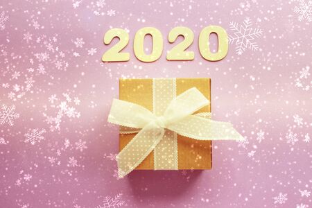 2020. Christmas background, Christmas composition. Gift box with ribbon,bokeh, white snowflakes, 2020 numbers. Copy space.の写真素材