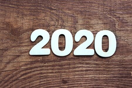 2020. Dark wood texture 2020.New year background. Retro wooden table. Rustic background. White snowflakes , snow, bokeh. Copy space.Christmas background, New year.Dark wood texture with white snowflakes. Christmas card, white snow, snow patterns.の写真素材