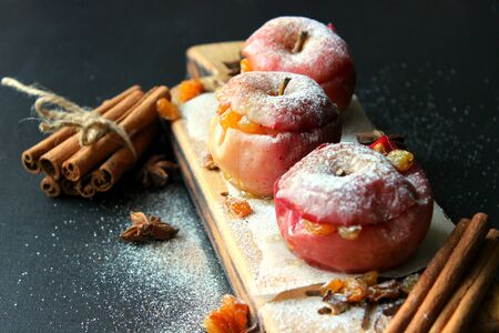 Baked apple with christmas spices on wooden