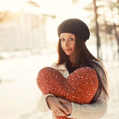 Young girl with big heart in arms. Valentine day.の写真素材