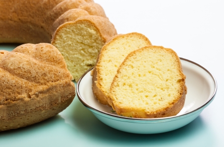 A macro view of the slices of a delicious golden brown crusted pound bundt cake baked in a ring shaped pan with fluted sides  The image has a shallow Depth-of-Field の写真素材