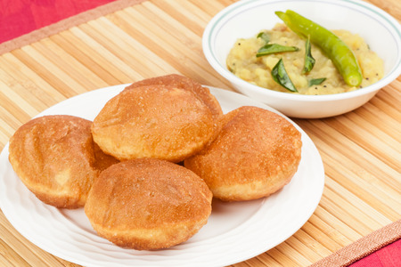 Delicious deep fried poori  puri  served with spicy potato onion curry  saagu  の写真素材