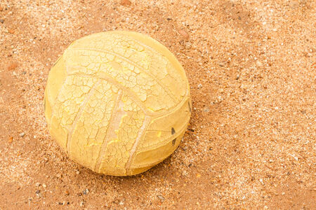 An old volley ball abandoned in a field の写真素材