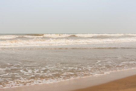 Frothy waves on beach - Incoming high frothy sea waves on a tropical beach in the evening.の写真素材