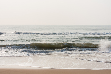 Calm waves on beach - Calm sea waves at morning time on a tropical beach.の写真素材