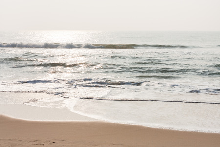 Glistening waves on beach - Glistening sea waves on a tropical beach in the morning.の写真素材
