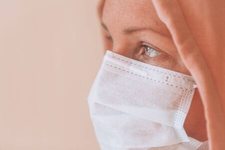 Portrait of a beautiful girl in a medical mask. Coronavirus epidemic, a concept on personal hygiene and protective face masks.の写真素材