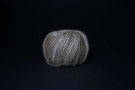 A ball of twine on a black background.