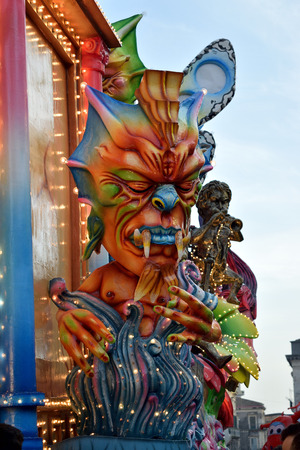 Acireale (CT), Italy - February 28, 2017: detail of a allegorical float depicting a colorful demon emerging from colored flames, during the carnival parade along the streets of Acireale.のeditorial素材