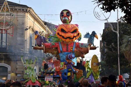 Acireale (CT), Italy - February 28, 2017: allegorical float, depicting a scarecrow with a pumpkin head and other vegetable's shaped characters, during the carnival parade along the streets of Acirealeのeditorial素材