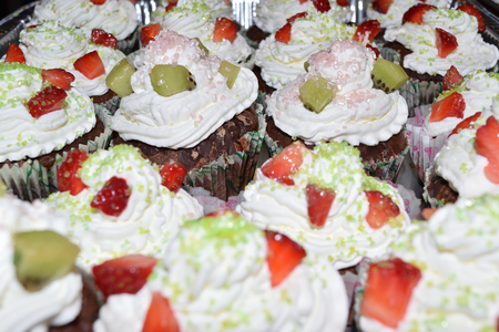 cup cakes with cream and various colorful decorationsの写真素材
