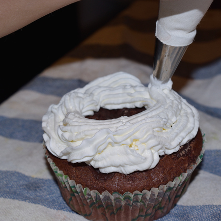 cup cakes with cream and various colorful decorationsの写真素材