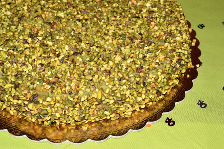 chocolate cake topped with chopped pistachios and pistachio creamの写真素材